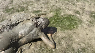 Estuary mud slut playing in the nude