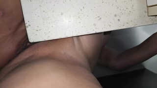 Wild chick grinding vagina on kitchen bench